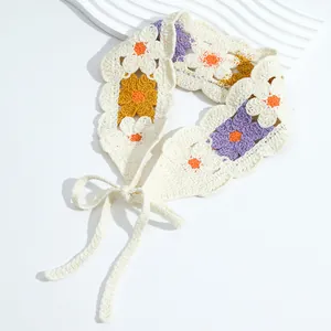 Detailed view of handmade crochet floral headband with purple and yellow knit patterns