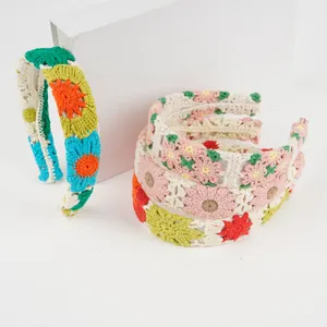 Detail of handmade knit flower headband with crochet sunflowers and daisies in vibrant colors