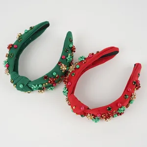 Detail of red and green knotted Christmas headbands with beads and metal bows