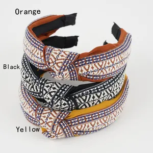 Three Bohemian style woven knotted headbands in orange black and yellow colors