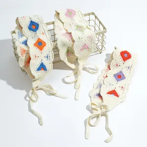 Detail of crochet floral headscarf set with hollow wavy edges and woven tie straps