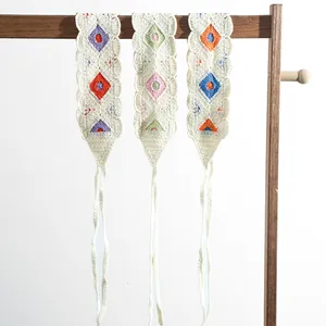 Detail of three handmade crochet floral headscarves with colorful diamond knit patterns