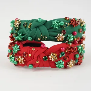 Detail of Christmas knot headbands with red and green pearls, rhinestones and golden bows