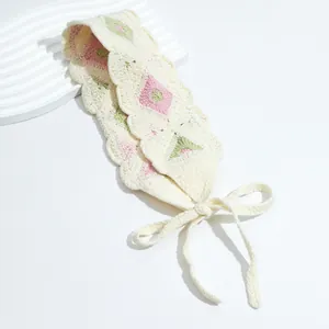 Detail of crochet floral headscarf with pink flowers and scalloped edges