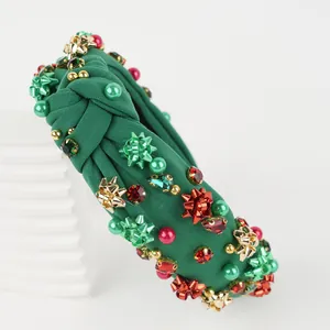 Detail of dark green knot headband with Christmas bows, red pearls and rhinestones
