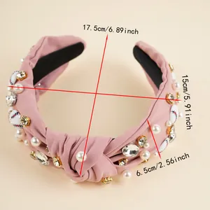 Pink knotted headband with baseball patterns, rhinestones and pearls detail view
