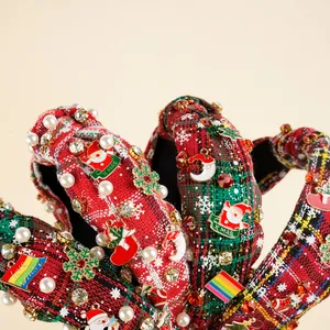 Close-up of Christmas knot headband with X-MAS Santa, pearls, and rhinestones
