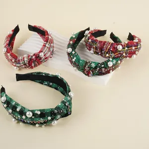 Detail of Christmas knitted headbands featuring plaid patterns with pearls and rhinestones
