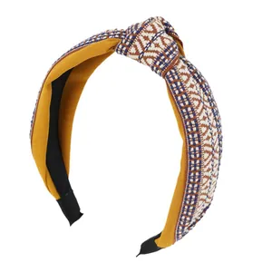 Vintage embroidery knotted headband with yellow fabric and geometric weave patterns