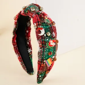 Detailed close-up of plaid Christmas headband with rhinestones and Santa charms