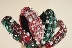 Close-up of knotted plaid headband with colorful rhinestones and faux pearl details
