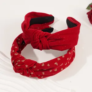 Red velvet New Year headbands with gold heart pattern and knotted bow design