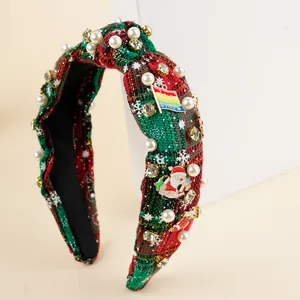Detail of red and green plaid Christmas headband with rhinestones, pearls and Santa charm