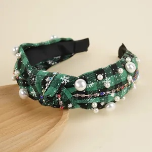 Close-up of Christmas plaid headband with pearls, rhinestones and snowflake patterns