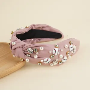 Detail of pink knotted headband with sewn pearls, crystals and baseball beads