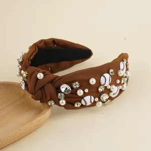 Close-up of brown knot headband with pearls, rhinestones, and mini baseball charms