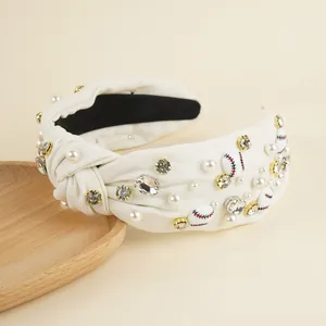 Detail of beaded baseball headband with white fabric knots, pearls and rhinestones
