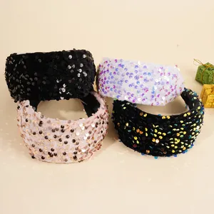 Detail shot of shimmering sequin velvet headbands in assorted colors for party styling
