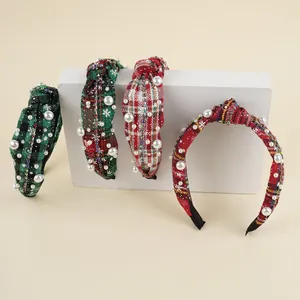 Detail of plaid headbands with pearls and rhinestones on a minimalist stand