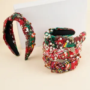 Detail of Christmas headband with red plaid fabric, faux pearls and X-MAS charms