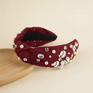 Detail of burgundy knotted headband featuring pearls, rhinestones and baseball motifs