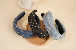 Detailed view of three knotted denim headbands with sparkling rhinestone embellishments