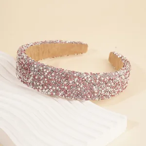 Detail of pink rhinestones and white pearls on wide headband with non-slip velvet lining