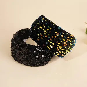 Detail of wide sequin headbands showing shimmering black and multi-color glitter texture