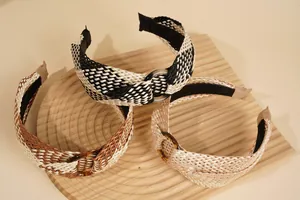 Close-up of bohemian raffia headband textures and elegant resin ring buckle details