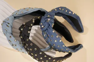Close-up of knotted denim headbands with sparkling rhinestones in blue and black colors