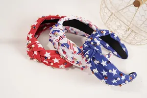 Detail of three patriotic knotted headbands with stars, pearls and rhinestones