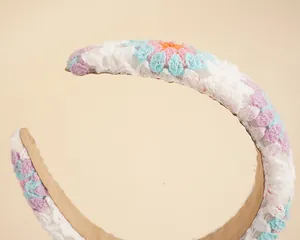 Macro shot of colorful handmade crochet floral headband with soft velvet inner lining