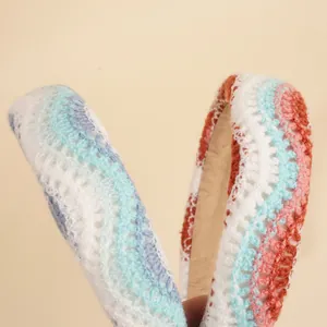 Detailed close-up of handmade crochet headband with bohemian knit wave pattern texture