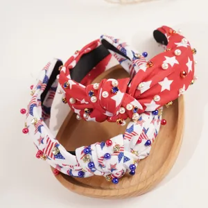 Detail of knotted headbands with US flag patterns, white pearls, and sparkling crystals