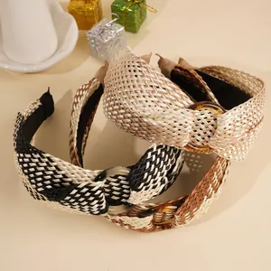 Detail of bohemian raffia knot headbands with decorative buckles and woven texture