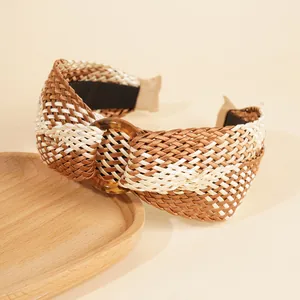 Detail of bohemian raffia headband showing intricate cross weave and amber resin ring