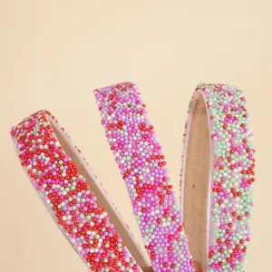 Handmade colorful beaded headband with vibrant purple, red, and mint green faux pearls