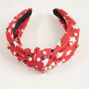 Knotted American flag headband with white stars, pearls and rhinestones on red fabric