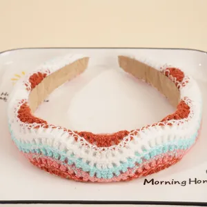 Detail of handmade crochet headband featuring colorful wavy knit patterns and soft texture