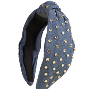 Knotted denim headband with sparkling rhinestones and gold settings on a wide hair hoop