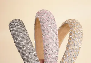 Macro detail of sparkling rhinestone headbands in gray, pink, and champagne colors