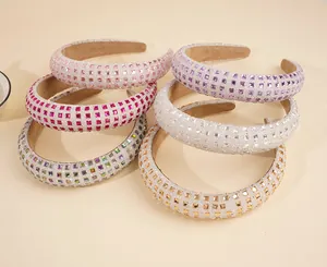 Detail of padded headbands featuring colorful rhinestones and glitter finish in six colors