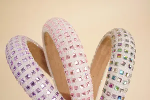 Close-up of padded headbands with sparkling square rhinestones in purple and pink