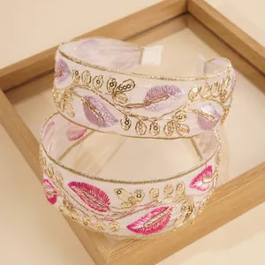 Close-up of bohemian leaf embroidery on organza headband with gold sequins and anti-slip teeth
