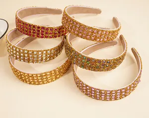 Macro detail of multi-colored rhinestone headbands with shimmering gold fabric backing