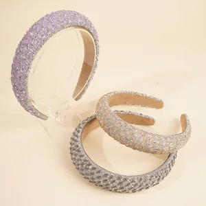 Detailed view of padded rhinestone headbands in purple, champagne, and silver grey colors