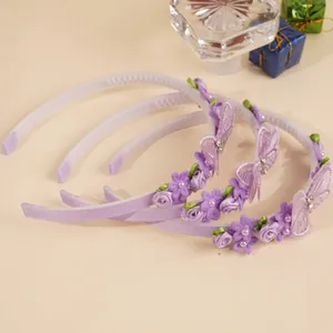 Detailed view of three purple headbands featuring fabric roses, lace butterflies, and pearls