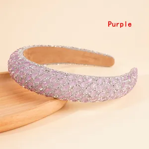 Detailed view of wide headband with purple marquise rhinestones and soft lining