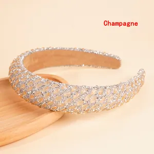 Macro shot of champagne sponge headband with sparkling rhinestones and crystal gems