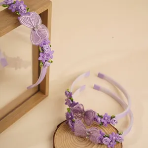 Detail of purple children's headbands with embroidered butterfly and fabric rose